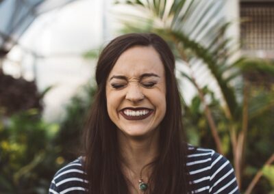 woman smiling while standing in garden